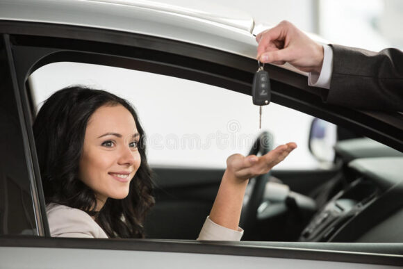 car-sales-happy-woman-receives-keys-to-new-manager-48897176