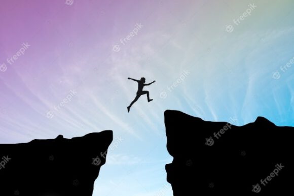 man-jump-through-gap-hill-man-jumping-cliff-blue-sky-business-concept-idea_1323-186